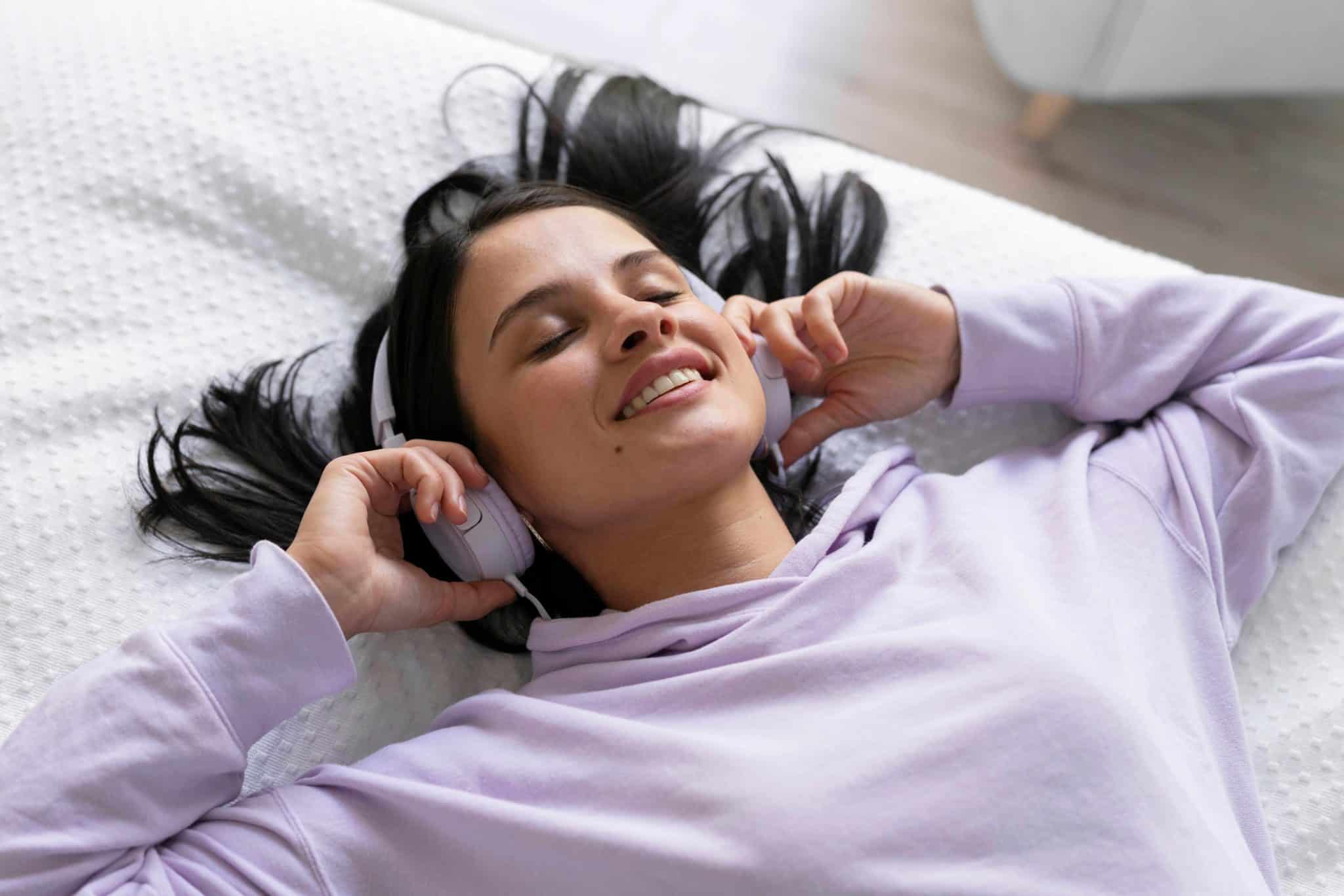 young woman listening music home compressed scaled