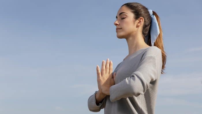 side view woman meditating nature