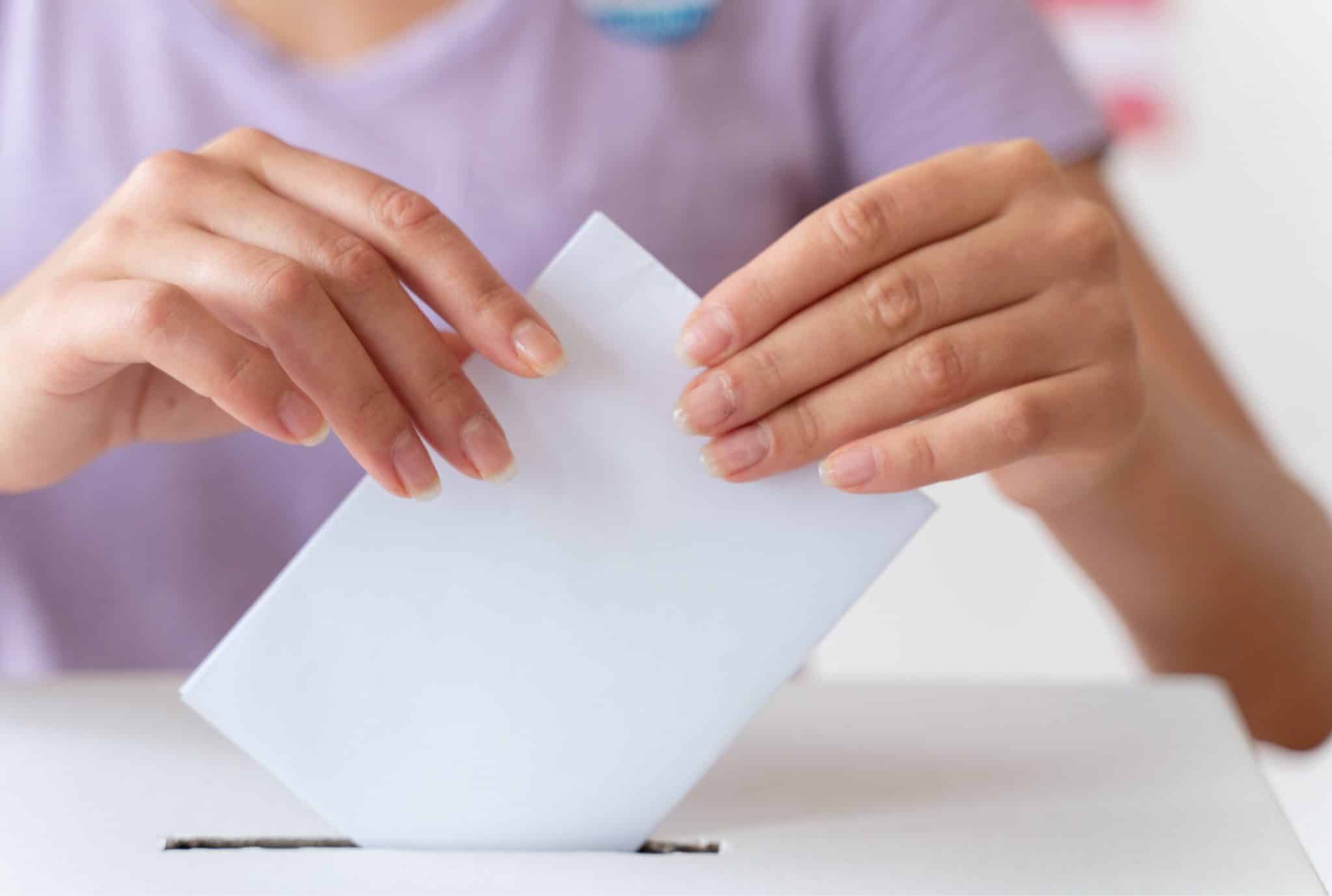 person placing its vote box scaled